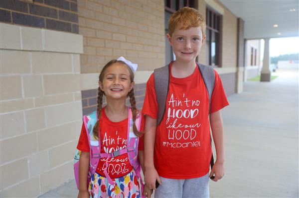 two students in red shirts